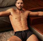 Model wearing navy Starr boxer briefs  in a cozy living room